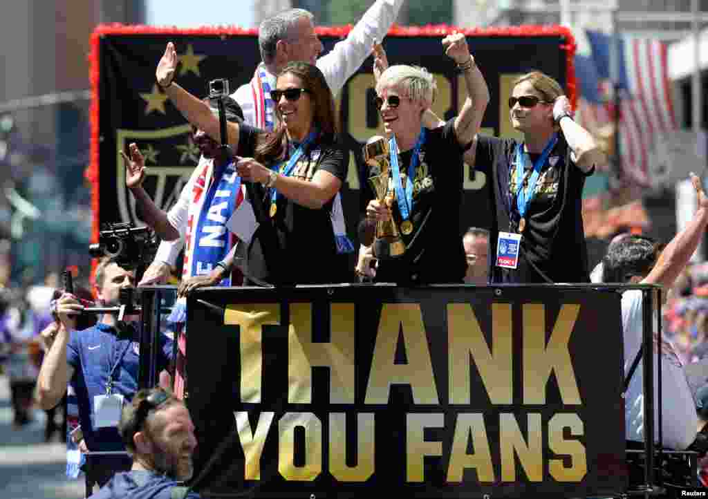 Carli Lloyd (left), Megan Rapinoe (center) and head coach Jill Ellis (right) make their way up Broadway in a ticker-tape parade to celebrate their Women&#39;s World Cup championship, July 10, 2015. (Robert Deutsch-USA TODAY Sports)