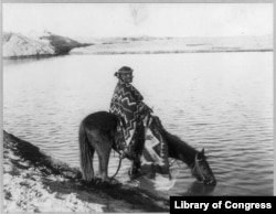 This circa 1913 photo shows a Navajo Indian seated on horse. The horse has always been considered sacred by the Navajo and figures prominently in songs and spiritual practices.
