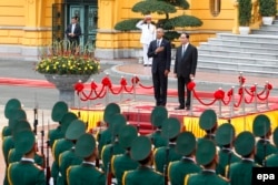 U.S. President Barack Obama (left) and Vietnam's President Tran Dai Quang review an honor guard at the Presidential Palace in Hanoi, Vietnam, May 23, 2016.