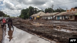 FILE — Streets in Katesh, Tanzania, are covered with mud following landslides and flooding triggered by heavy rainfall, Dec. 5, 2023.