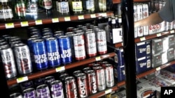 FILE - This April 19, 2017 file photo shows the beer cooler behind the counter in a convenience store in Sheridan, Indiana.