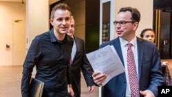  Max Schrems (L) and his lawyer, Herwig Hofmann, are seen walking in a hallway of the European Court of Justice in Luxembourg on Oct. 6, 2015.