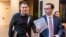  Max Schrems (L) and his lawyer, Herwig Hofmann, are seen walking in a hallway of the European Court of Justice in Luxembourg on Oct. 6, 2015.