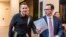 FILE - Max Schrems (L) and his lawyer, Herwig Hofmann, are seen walking in a hallway of the European Court of Justice in Luxembourg on Oct. 6, 2015.