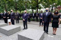 From left, New York Gov. Andrew Cuomo, Jill Biden with her husband Democratic presidential candidate Joe Biden, former NYC Mayor Mike Bloomberg, Vice President Mike Pence and his wife Karen, observe a moment of silence in New York, Sept. 11, 2020.