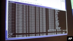 FILE - A computer screen shows a password attack in progress at the Norwich University computer security training program in Northfield, Vermont.