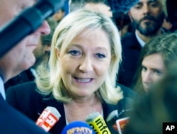 FILE - French far-right leader and National Front Party, Marine Le Pen speaks to the media after a news conference at party headquarters, March 22, 2015, in Nanterre, western France.