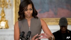 First lady Michelle Obama, speaks to welcome middle school students from the Washington area for an interactive student workshop, Oct. 14, 2015, in the State Dining Room of the White House in Washington. 