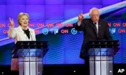 FILE - Democratic presidential candidates Sen. Bernie Sanders, I-Vt., right, and Hillary Clinton speak during the CNN Democratic Presidential Primary Debate at the Brooklyn Navy Yard, April 14, 2016.