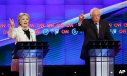 Democratic presidential candidates Sen. Bernie Sanders, I-Vt., right, and Hillary Clinton speak during the CNN Democratic Presidential Primary Debate at the Brooklyn Navy Yard, April 14, 2016.