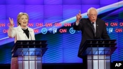 FILE - Democratic presidential candidates Hillary Clinton, left, and Sen. Bernie Sanders speak during the CNN Democratic Presidential Primary Debate at the Brooklyn Navy Yard, April 14, 2016.