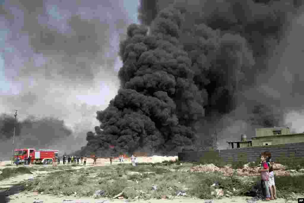Iraqi firefighters battle large fire at oil wells as they trying to prevent the flames from reaching the residential neighborhoods in Qayara, Iraq, Aug. 31, 2016. Oil wells on the edge of Qayara burn days after the key town south of was retaken from the Islamic State group by Iraqi ground forces backed by U.S.-led coalition airpower.