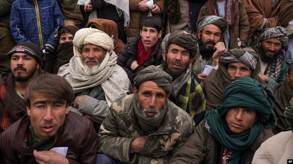 FILE - Hundreds of Afghan men gather to apply for the humanitarian aid in Qala-e-Naw, Afghanistan, Tuesday, Dec. 14, 2021. (AP Photo/Mstyslav Chernov, File)