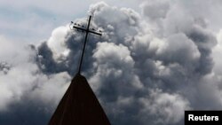 FILE - A cross is seen atop a church steeple in Indonesia's North Sumatra province, Nov. 30, 2013. Three churches on Indonesia's Sumatra Island were sealed by authorities Thursday.