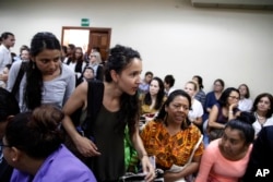 Bertha Zuniga Caceres, center, daughter of the murdered Honduran environmentalist Berta Caceres, arrives in court for the trail of her mother’s muder, in Tegucigalpa, Honduras, Sept. 17, 2018.