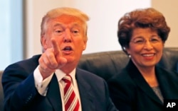Donald Trump, during a Hispanic advisory meeting in New York, Aug. 20, 2016, is considering Jovita Carranza (right) as U.S. Trade Representative.