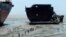 Workers carry a long rope at a ship-breaking yard in Chittagong, Bangladesh July 16, 2013. Bangladesh is dependent on ship-breaking for its domestic steel requirements. According to a report by the Bangladesh Institute of Labour Studies, around 30,000 wor