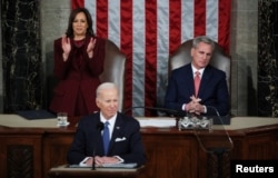 Wakil Presiden AS amala Harris berdiri dan bertepuk tangan sementara Ketua DPR Kevin McCarthy tetap duduk setelah Presiden Joe Biden mengatakan "Keadaan serikat kuat" saat menyampaikan pidato kenegaraannya di Gedung Capitol AS di Washington, AS, 7 Februari 2023. (REUTERS/Leah Millis)