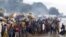 FILE - Burundian refugees gather on the shores of Lake Tanganyika in Kagunga village in Kigoma region in western Tanzania, as they wait for MV Liemba to transport them to Kigoma township, May 17, 2015. 