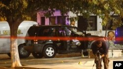 A member of a forensic team works at a crime scene where five men were gunned down in Ciudad Juarez July 12, 2011