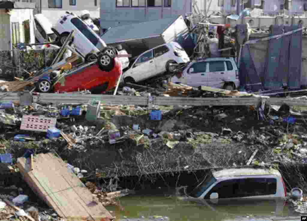 Displaced vehicles are seen at Sendai Port in Sendai, northeastern Japan, Saturday, March 12, 2011, following Friday's 8.9-magnitude quake and the tsunami it spawned hit the country's northeastern coast. (AP Photo/Koji Sasahara)