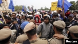 Public order officers block protesters demonstrating over labour issues in an industrial area of Tangerang on the outskirts of Jakarta, October 3, 2012. 