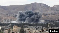 Smoke rises from an explosion in besieged Eastern Ghouta in Damascus, Syria, Feb. 27, 2018. 