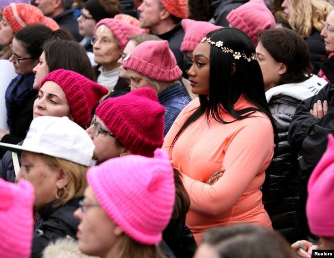 FILE - People listen to speeches at the Women's March in opposition to the agenda and rhetoric of President Donald Trump in Washington, Jan. 21, 2017.