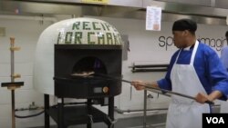 Inmates at the Cook County Jail in Chicago make pizza under the watch of Bruno Abate.