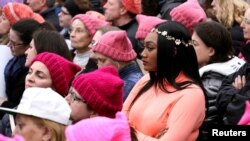 FILE - People listen to speeches at the Women's March in opposition to the agenda and rhetoric of President Donald Trump in Washington, Jan. 21, 2017.