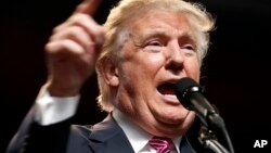 FILE - Republican presidential candidate Donald Trump gestures during a rally in Charleston, W.Va., May 5, 2016. 