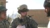 Army 1st Lieutenant Sean Mahard (C) talks with Afghans in Logar province