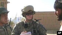 Army 1st Lieutenant Sean Mahard (C) talks with Afghans in Logar province