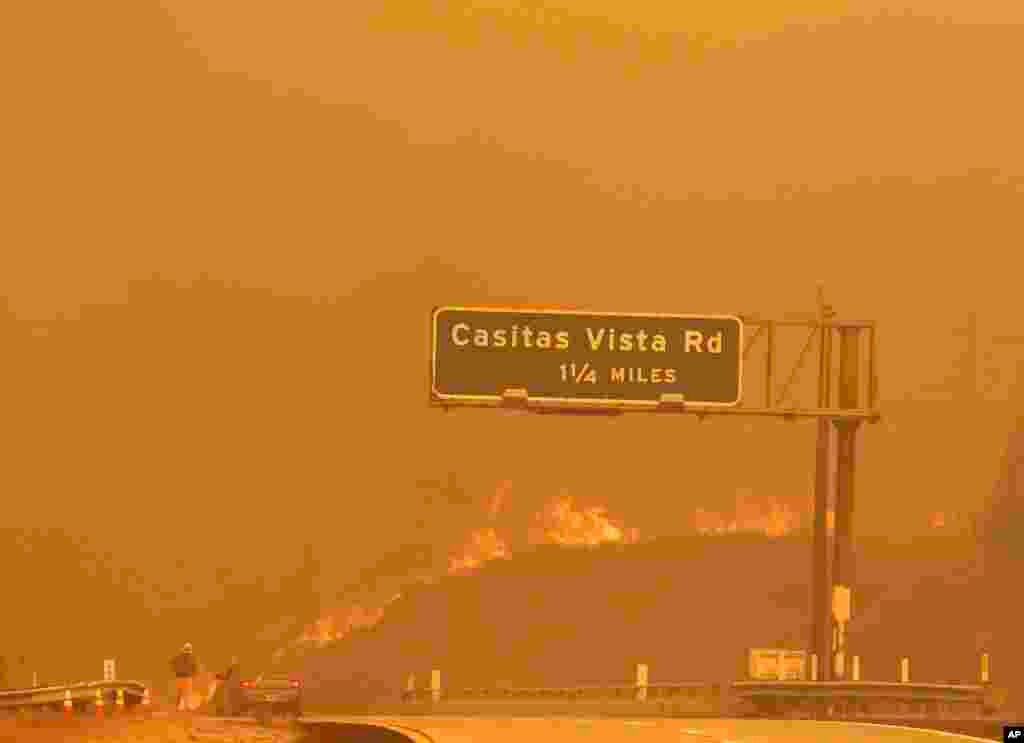 Flames and smoke shroud State Route 33 as a wildfire burns in Ventura, California, Dec. 5, 2017.