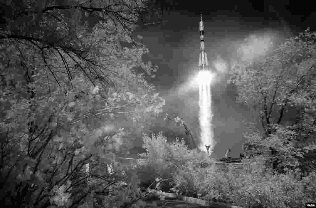 In this black and white infrared image, the Soyuz MS-09 rocket is launched with Expedition 56 Soyuz Commander Sergey Prokopyev of Roscosmos, flight engineer Serena Auñón-Chancellor of NASA, and flight engineer Alexander Gerst of ESA (European Space Agency), at the Baikonur Cosmodrome in Kazakhstan.