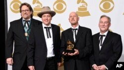 FILE - Members of the Earls of Leicester — from left, Jerry Douglas, Shawn Camp, John Warren and Charlie Cushman — pose with their award for best bluegrass album at the 57th annual Grammy Awards in Los Angeles, Feb. 8, 2015. The band has received eight International Bluegrass Music Association award nominations.