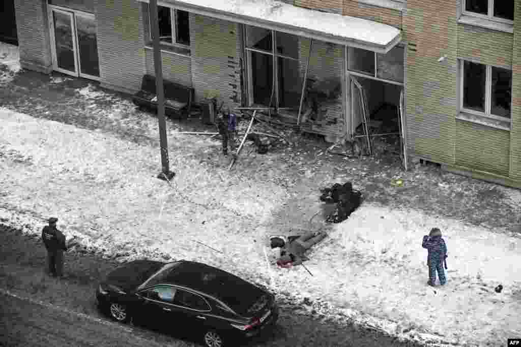 Bodies of the commander of Russian armed forces&#39; chemical, biological and radiation defence troops, Igor Kirillov, (top) and his assistant are seen at the blast scene outside a residential building on Ryazansky Avenue in Moscow.