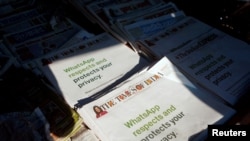 FILE - A WhatsApp advertisement is seen on the front pages of newspapers at a stall in Mumbai, India, Jan. 13, 2021.