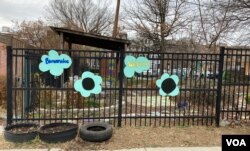 Signs welcome visitors to Girard Children's Community Garden in Washington, D.C.