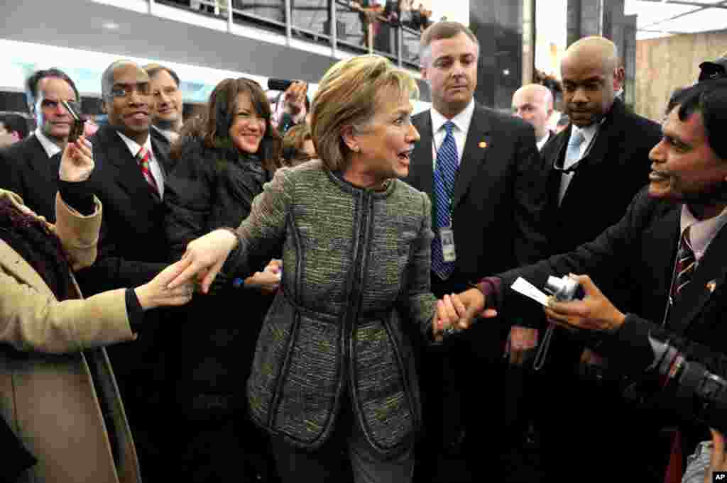 State Department employees welcome Hillary Clinton to the State Department building in Washington, January 22, 2009.