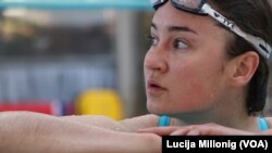 Russian international student Olesia Altynbaeva stops for a rest while swimming in one the pool at UC San Diego.