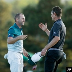 Sergio Garcia, left, shakes hands with Justin Rose, after making his birdie putt on the 18th green to win the Masters.