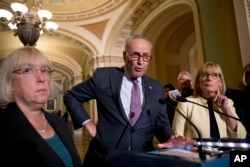 FILE - Senate Minority Leader Sen. Chuck Schumer of N.Y., accompanied by Sen. Patty Murray, D-Wash., left, and Sen. Maggie Hassan, D-N.H., right, speaks to reporters as Senate Republicans faced defeat on the Graham-Cassidy bill, the GOP's latest attempt to repeal the Obama health care law, at the Capitol in Washington, Sept. 26, 2017.