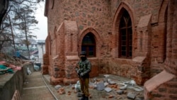 An Indian paramilitary soldier stands guard outside a newly renovated St Luke's Church during Christmas celebrations in Srinagar, Indian-controlled Kashmir, Dec. 25, 2021.