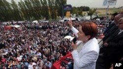 FILE - Meral Aksener, a former Interior minister and the main contester for leadership, addresses supporters as riot police sealed off a hotel to prevent thousands of dissidents in Turkey's opposition Nationalist Movement Party, the MHP, from holding a party congress to oust Devlet Bahceli, leader for the last two decades, in Ankara, Turkey, May 15, 2016.