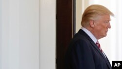 President Donald Trump watches Turkish President Recep Tayyip Erdogan departs following Erdogan's visit to the White House in Washington, May 16, 2017.