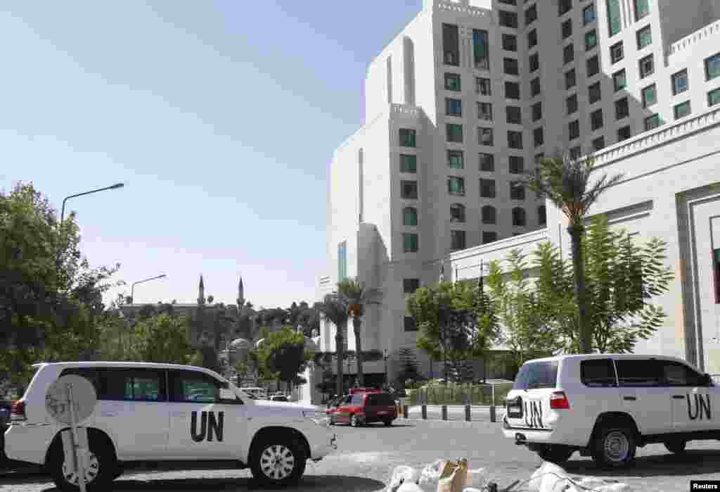 United Nations vehicles are parked in front of the Four Seasons hotel, where a team of experts from the Organisation for the Prohibition of Chemical Weapons (OPCW) is staying in Damascus, Oct. 22, 2013.