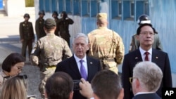 FILE - U.S. Defense Secretary Jim Mattis, center, speaks to the media as South Korean Defense Minister Song Young-moo, right, looks on during a visit to the truce village of Panmunjom in the Demilitarized Zone (DMZ), Oct. 27, 2017.