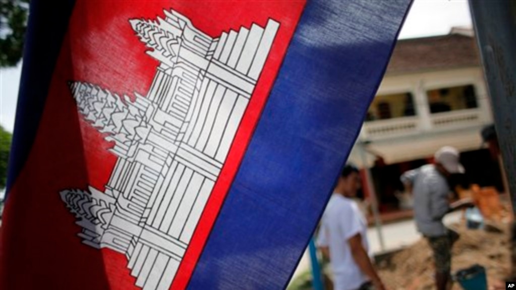 FILE: In this Saturday, July 17, 2010 photo, a Cambodian flag with a depiction of Angkor Wat in the center is hoisted near a construction site in Siem Reap, about 143 miles (230 kilometers) northwest of the capital, Phnom Penh, Cambodia.