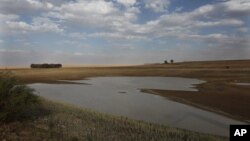 FILE - Taps and water sources are dry in South Africa's almost depleted local dam in Senekal, Jan. 7, 2016. Senekal, a small town in South Africa’s rural Free State province, is one of four regions declared disaster areas as drought dries up the country's heartland.